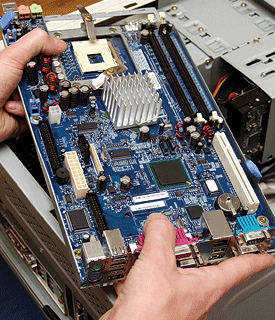 Compudoc installing a motherboard.